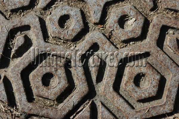 manhole hexagon pattern shadow dirty weathered industrial metal dark brown