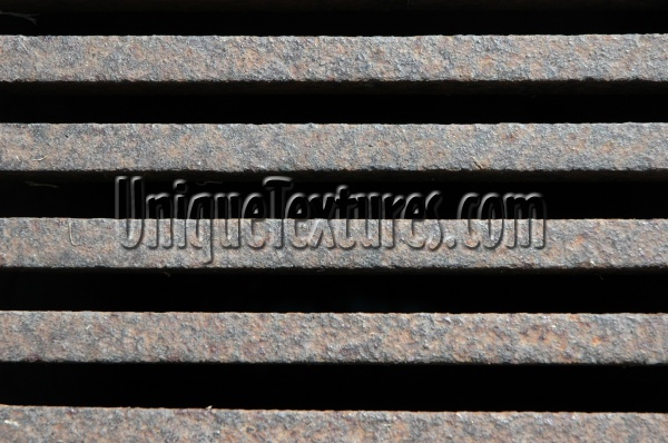 vent/drain horizontal rusty industrial architectural metal dark brown black