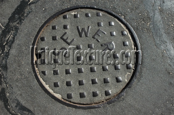 street manhole square round textual shiny industrial asphalt metal metallic gray