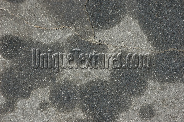 gray asphalt vehicle stained random spots street
