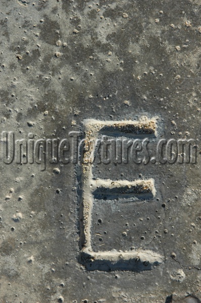 gray concrete industrial textual shadow spots manhole