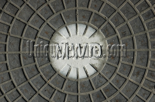 gray white metal industrial textual round pattern manhole street