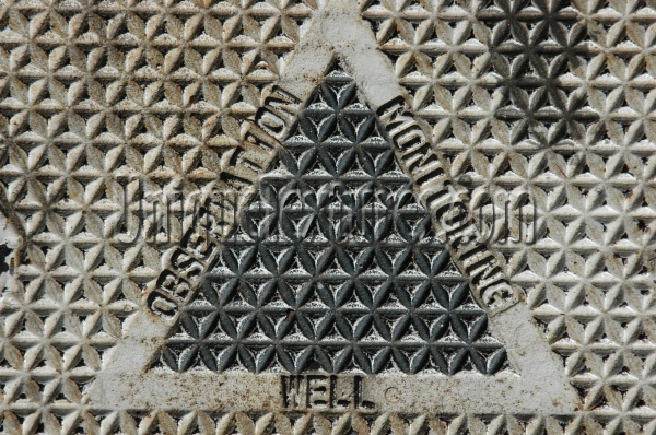 manhole triangular textual industrial metal gray
