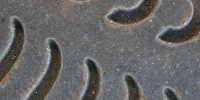 vent/drain curves rusty industrial metal dark brown