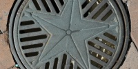gray metal industrial round pattern symbol vent/drain    