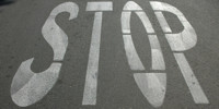 street sign oblique textual vehicle     asphalt paint white black