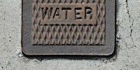 door manhole rectangular diamonds textual rusty industrial metal dark brown gray