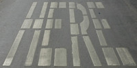 gray white paint asphalt vehicle oblique sign